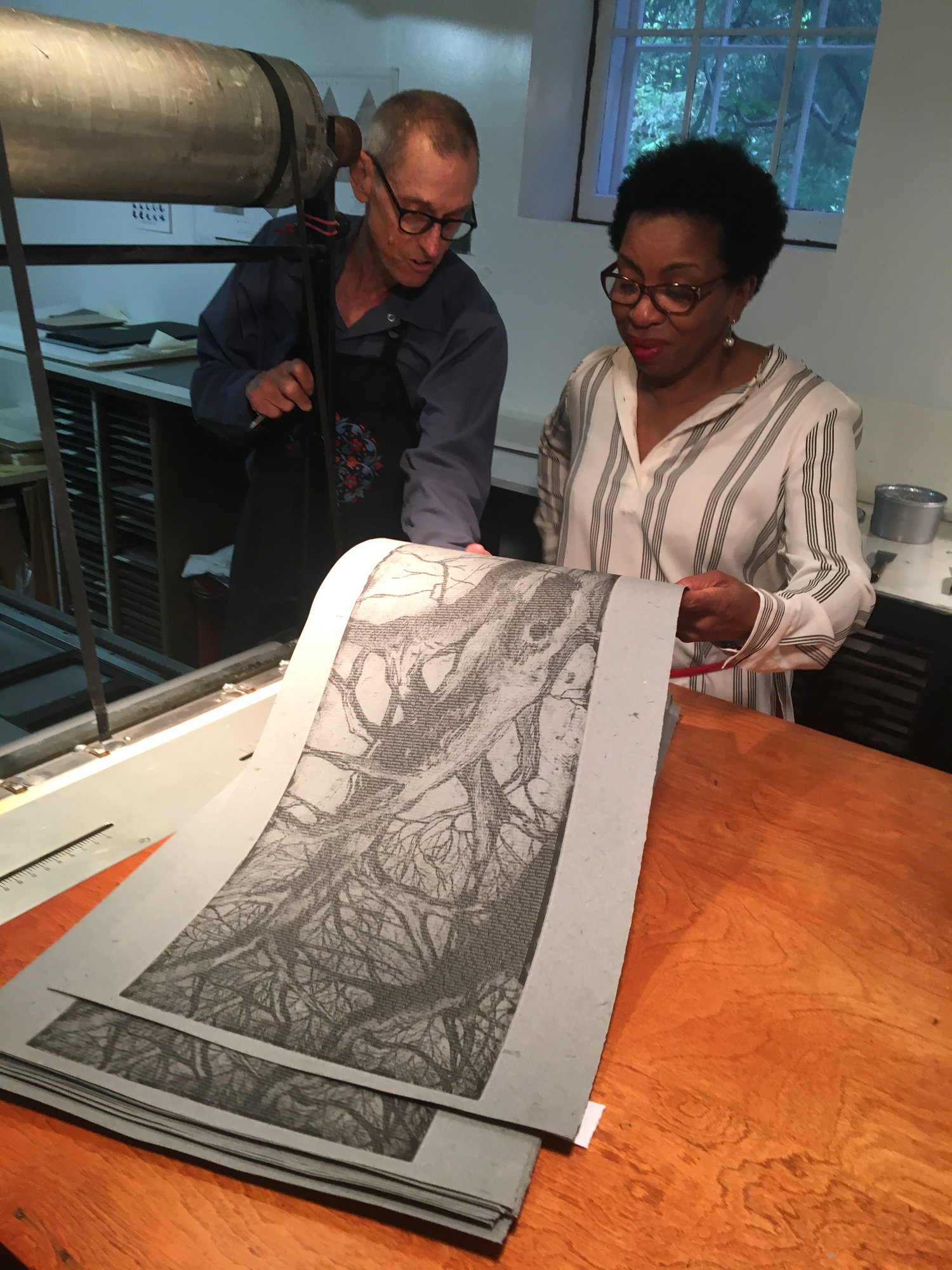 Shirley Ann Whitaker with printer, reviewing the Ashes to Ashes broadside